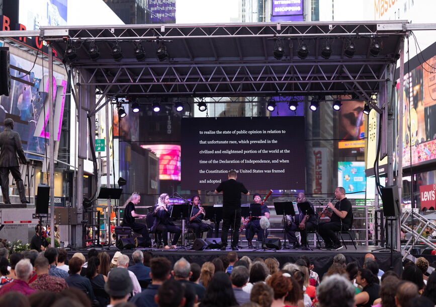 Musicians play on a stage in Times Square.